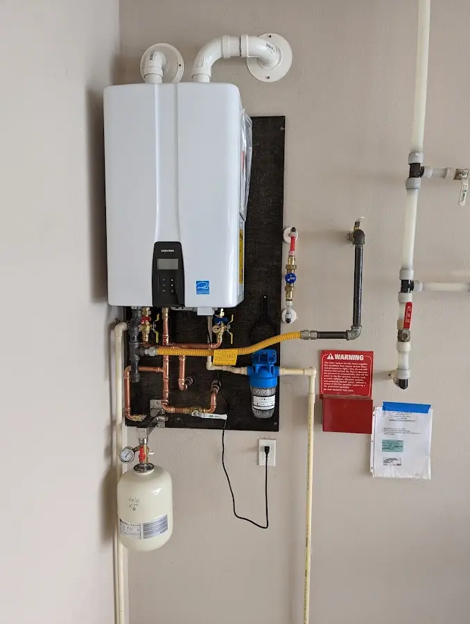 Professional plumber installing copper piping in a Youngtown home